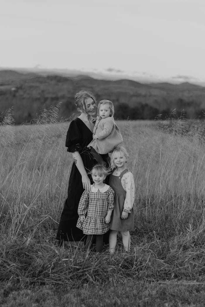 about-us-02 Heartfelt family moment captured in a rustic outdoor field setting