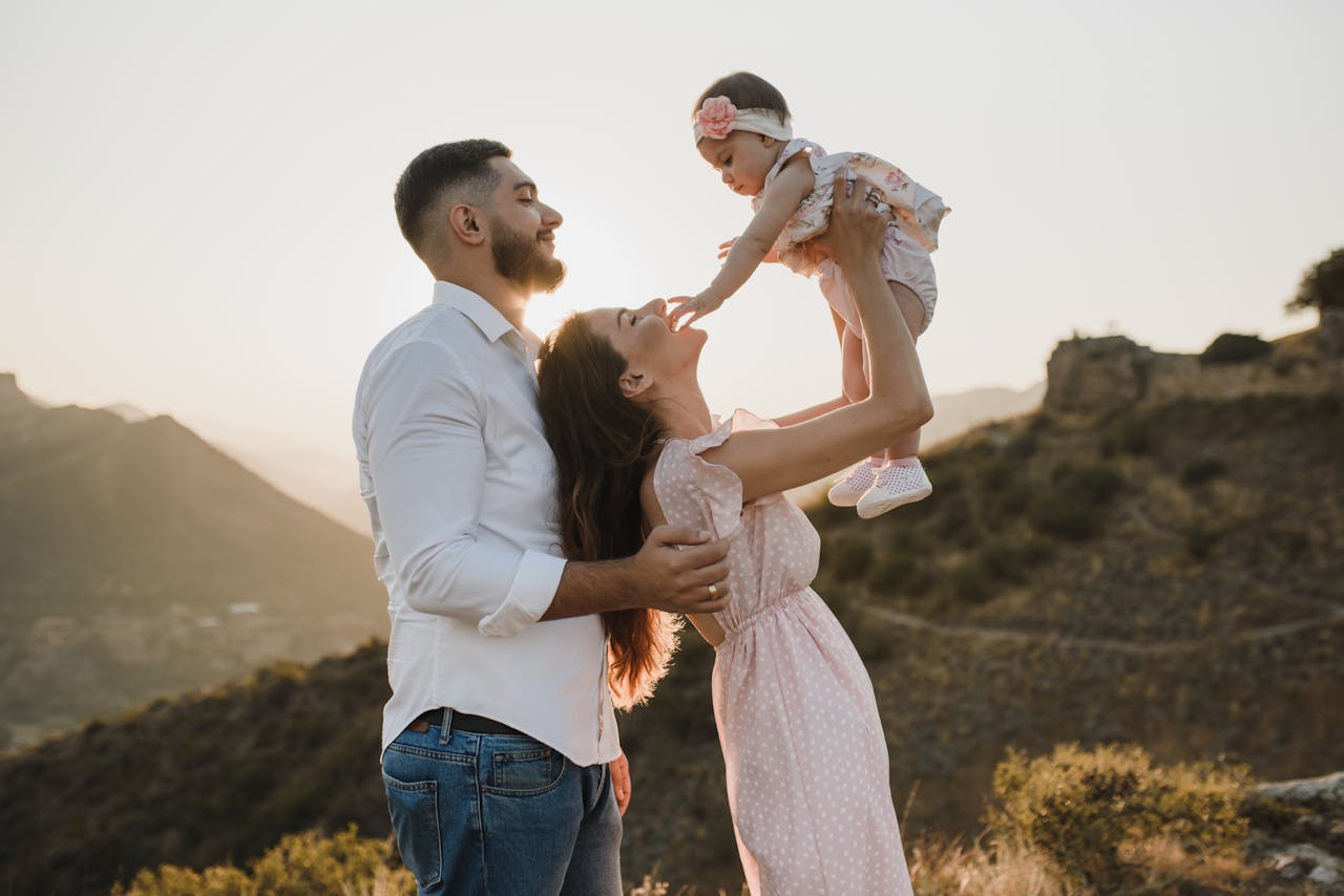 A joyful family bonding outdoors during a beautiful sunset, capturing love and togetherness.